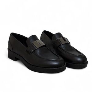 DKNY Issa Metal Logo Slip On loafers in black synthetic leather
